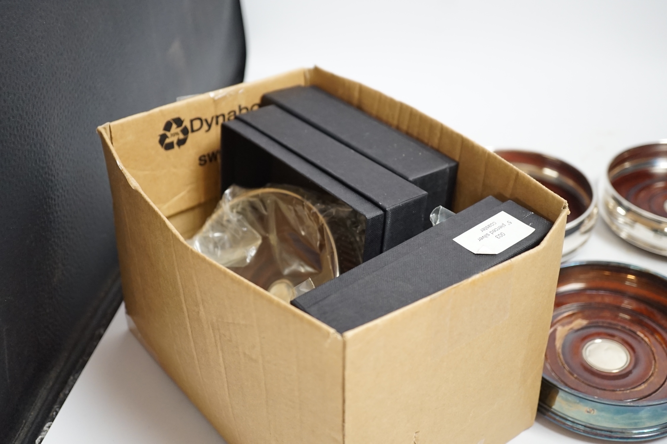 Six modern silver mounted wine coasters, including pierced pair, London, 2009, diameter 12.5cm, three boxed in total.